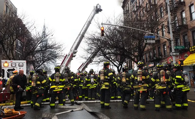 Firefighters work to extinguish a fire in a building that collapsed in New York City, March 26, 2015. (Photo by Justin Lane/EPA)