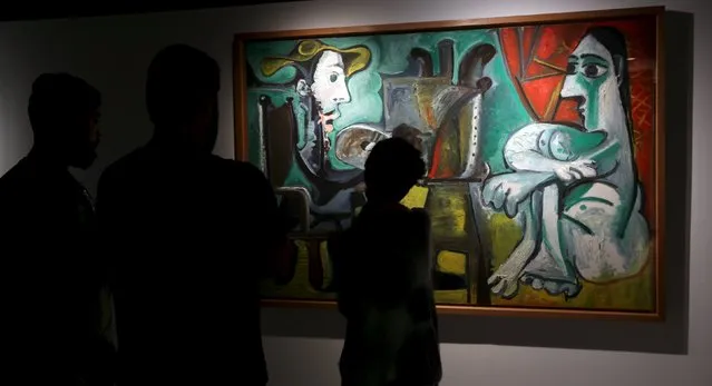 People stand in front of the painting “The Paintor and the Model” from 1963 by Spanish artist Pablo Picasso at the exhibition “Picasso and the Spanish modernity” at Centro Cultural Banco do Brazil in Sao Paulo March 25, 2015. (Photo by Paulo Whitaker/Reuters)
