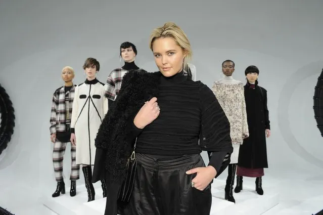 Model Georgina Burke poses with models at the Michelle Helene Presentation at Pier 59 on February 13, 2016 in New York City. (Photo by Arun Nevader/Getty Images)
