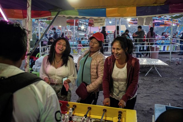 Women play a carnival game in the region where Shining Path, the Peruvian guerrilla group whose founder Abimael Guzman recently died, was once active, in Ayacucho, Peru on September 12, 2021. (Photo by Alessandro Cinque/Reuters)