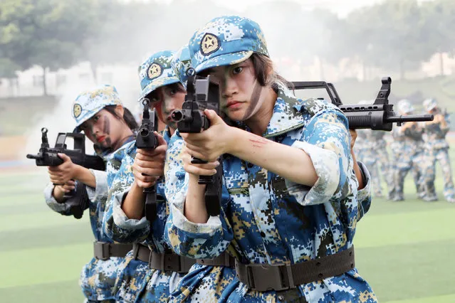 Freshmen take part in a military training at Chongqing City Vocational College on September 23, 2021 in Chongqing, China. (Photo by Chen Shichuan/VCG via Getty Images)