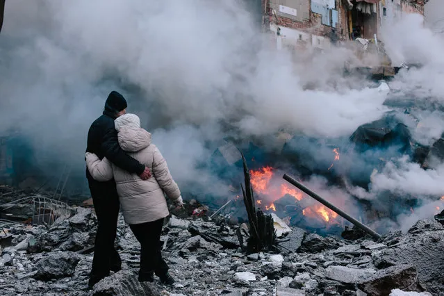 A man and a woman watch the progress of a search and rescue effort at an apartment building ruined in the Russian missile attack on Kharkiv, northeastern Ukraine. As reported, the Russian missile strike which took place Tuesday morning, January 23, has claimed the lives of seven people and has left 63 people injured in the northeastern Ukrainian city of Kharkiv. (Photo by Pavlo Pakhomenko/NurPhoto/Rex Features/Shutterstock)