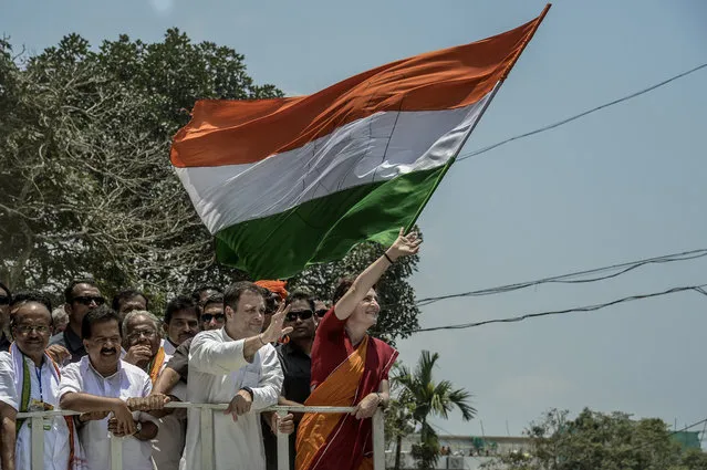 Rahul Gandhi & Priyanka Gandhi wave at the crowd in the road show after Rahul Gandhi filing nominations from Wayanad district on April 4, 2019 in Kalpetta town in Wayanand, India. Rahul Gandhi, the scion of India's unofficial first family, took position as president of India National Congress while challenging Prime Minister Narendra Modi and his Bharatiya Janata Party (BJP) during the country's general election after suffering his worst ever defeat in 2014. The 48-year-old reluctant political leader is the son of former Prime Minister Rajiv Gandhi and grandson of India's only female Prime Minister Indira Gandhi, who were both assassinated, but hopes to claim the prime ministership while facing constant criticism as leader of the Congress. Around 900 million people will be casting their ballots during India's general election, which is scheduled from 11 April to 19 May and considered the world's biggest democratic exercise. (Photo by Atul Loke/Getty Images)