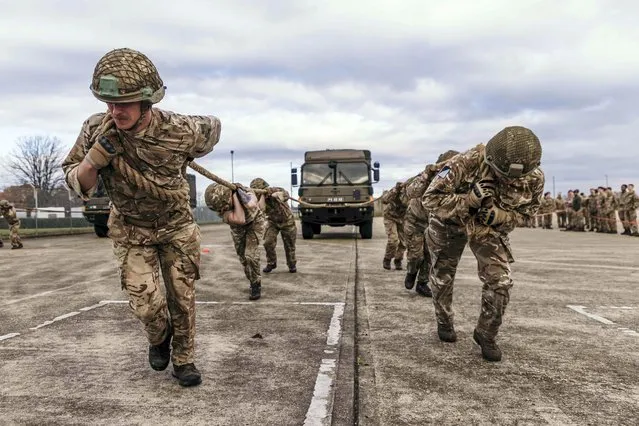 Members of the Royal Electrical and Mechanical Engineers take part in a competition to pull a six-tonne lorry on December 8, 2022. Seven teams from 16 Air Assault Brigade took part in the competition at Merville Barracks, in Colchester, UK which included running for two miles in full kit while carrying a 36lb rucksack. (Photo by Cpl Danny Houghton Royal Army)
