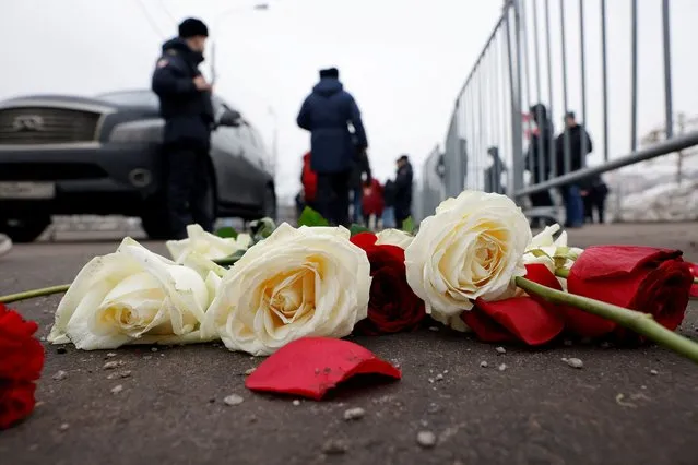 Flowers are left on the ground near the Borisovskoye cemetery during the funeral of Russian opposition politician Alexei Navalny in Moscow, Russia, on March 1, 2024. (Photo by Reuters/Stringer)