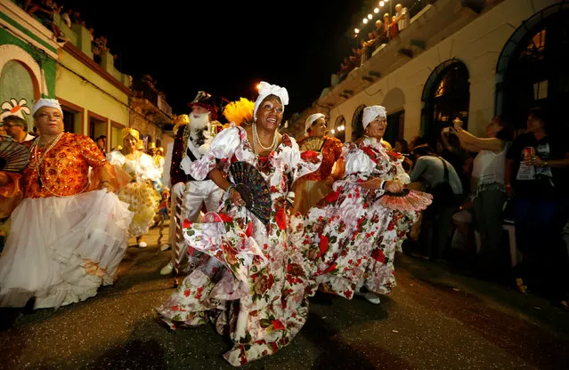 Members of a comparsa, a Uruguayan carnival group, dance during the Llamadas parade, a street fiesta with traditional Afro-Uruguayan roots, in Montevideo February 10, 2017. (Photo by Andres Stapff/Reuters)
