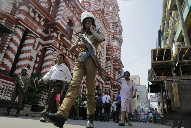 A Sri Lankan police officer patrols out side a mosque in Colombo, Sri Lanka, Wednesday, April 24, 2019. The Islamic State group has claimed responsibility for the Sri Lanka attacks on Easter Sunday and released images that purported to show the attackers. Prime Minister Ranil Wickremesinghe said that investigators were still determining the extent of the bombers' foreign links. (Photo by Eranga Jayawardena/AP Photo)