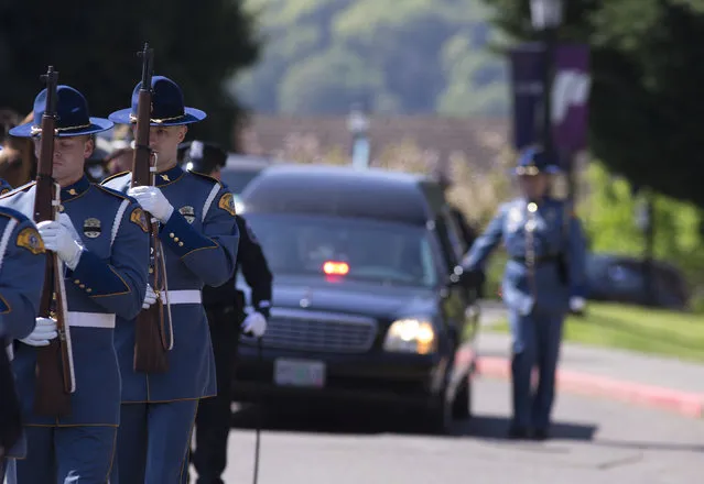 A procession honoring Cowlitz County Deputy Justin DeRosier makes its way to the Chiles Center at the University of Portland, where a memorial service is taking place for the slain deputy, Wednesday, April 24, 2019 in Portland, Ore. (Photo by Beth Nakamura/The Oregonian via AP Photo)