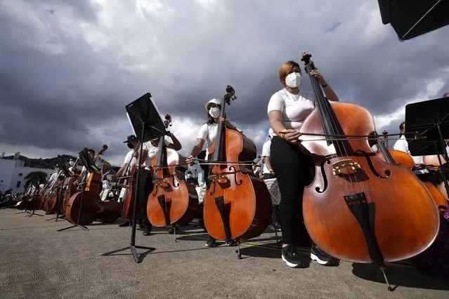 Members of the National Orchestra System gather to try and break a Guinness World Record for most instruments used in a piece of music, in Caracas, Venezuela, Saturday, November 13, 2021. (Photo by Ariana Cubillos/AP Photo)