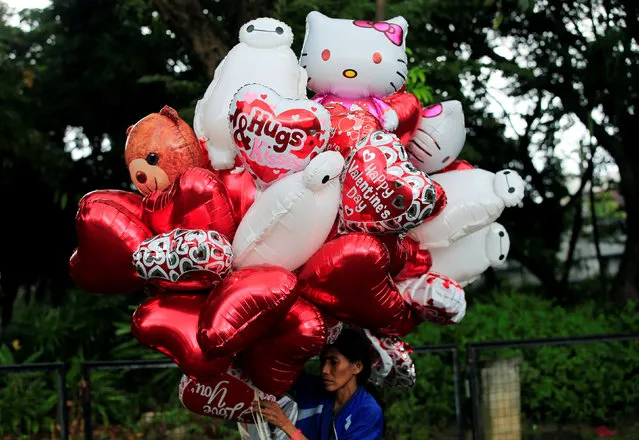 A vendor sells balloons a day before Valentine's Day in Rizal park, in metro Manila, Philippines February 13, 2017. (Photo by Romeo Ranoco/Reuters)