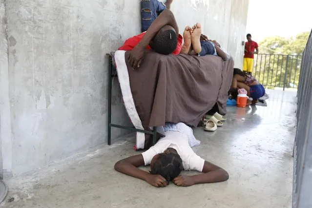 Residents who were displaced from their homes due to clashes between police and gang members, rest at a public school serving as a shelter in Port-au-Prince, Haiti, Friday, March 8, 2024. (Photo by Odelyn Joseph/AP Photo)