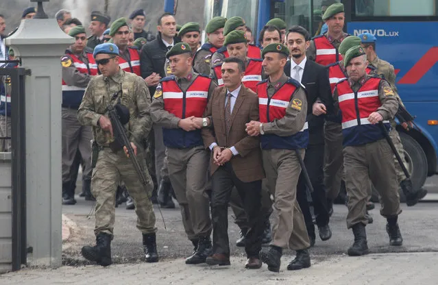 Zekeriya Kuzu, one of the main suspects accused of attempting to assassinate Turkish President Tayyip Erdogan on the night of the failed last year's July 15 coup, and the other soldiers are escorted by Turkish gendarmes as they arrive for the first hearing of the trial in Mugla, Turkey, February 20, 2017. (Photo by Kenan Gurbuz/Reuters)