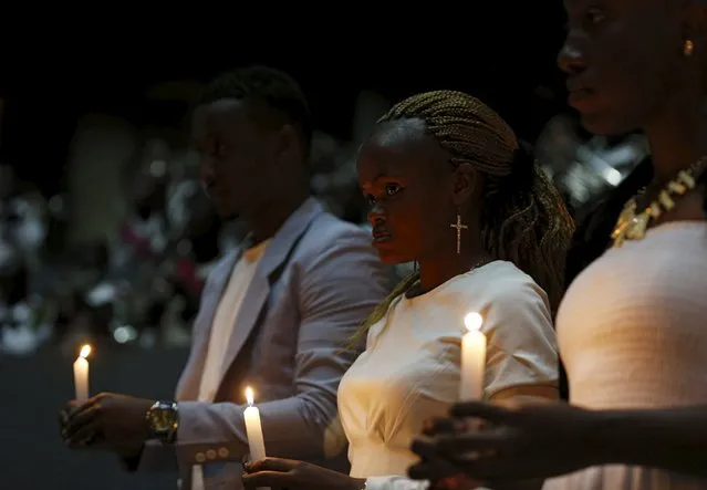 Students of Garissa University and a survivors of the gunmen attack hold burning candles during prayers to commemorate the first anniversary of the attack at the Garissa University College, in Kenya's capital Nairobi, April 2, 2016. (Photo by Thomas Mukoya/Reuters)