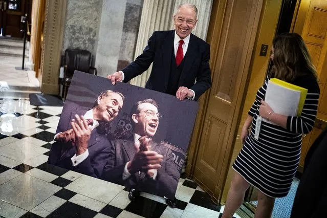 Sen. Chuck Grassley (R-IA) shows off a photograph of former Senate Majority Leader, Bob Dole, R-Kansas, and himself, following a floor speech where he called Dole “my best friend in the United States Senate”, and closed with “Godspeed, my friend” in the U.S. Capitol on Monday, December 6, 2021 in Washington, DC. (Photo by Al Drago/The Washington Post)