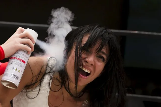 Wrestler Kris Wolf receives ice spray treatment during her Stardom professional wrestling show at Korakuen Hall in Tokyo, Japan, July 26, 2015. (Photo by Thomas Peter/Reuters)