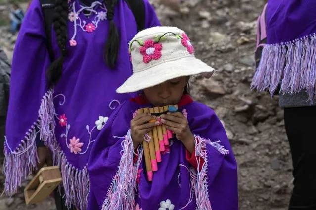 A young pilgrim plays an Andean flute during a religious procession in honor of the Virgin of Punta Corral as part of Holy Week festivities in Tilcara, Jujuy province, Argentina, Wednesday, March 27, 2024. (Photo by Rodrigo Abd/AP Photo)