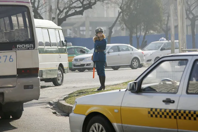 In this December 1, 2015, file photo, a North Korean traffic police officer directs vehicles in Pyongyang, North Korea. (Photo by Wong Maye-E/AP Photo)
