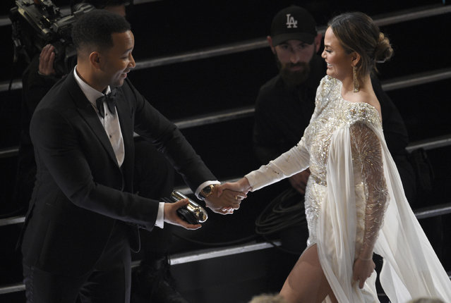 John Legend, left, and Chrissy Teigen appear in the audience at the Oscars on Sunday, February 26, 2017, at the Dolby Theatre in Los Angeles. (Photo by Chris Pizzello/Invision/AP Photo)