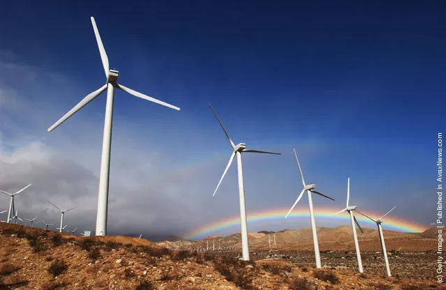 The first storm of the season produces a rainbow behind wind turbines in the San Gorgonio Pass November 9, 2002 near Palm Springs, California
