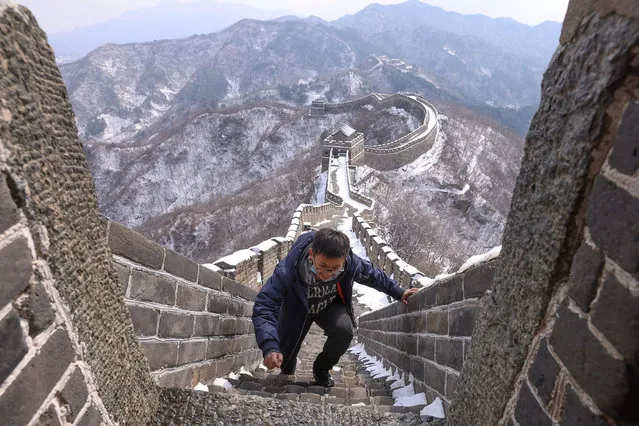A Chinese tourist visits the Mutianyu Great Wall covered in snow on February 23, 2021 in Beijing, China. Affected by the new coronavirus (COVID-19), the number of visitors to Mutianyu Great Wall in 2020 dropped by about 60%. (Photo by Lintao Zhang/Getty Images)