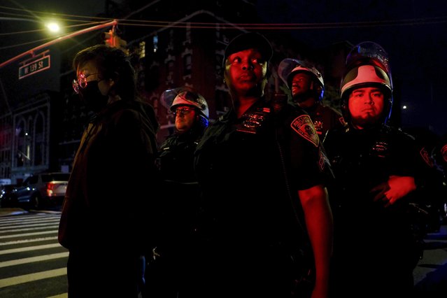 New York Police escort protesters onto a bus after making arrests during a standoff between police and demonstrators outside the City College of New York, Wednesday, May 1, 2024, in New York. (Photo by Julius Motal/AP Photo)