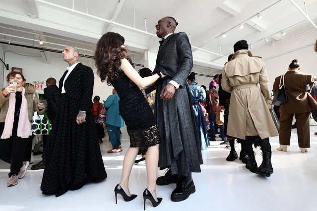 A model has his outfit adjusted during the Terry Singh Fall/Winter 2023 collection presentation at New York Men's Day during New York Fashion Week in New York City, U.S., February 10, 2023. (Photo by Andrew Kelly/Reuters)