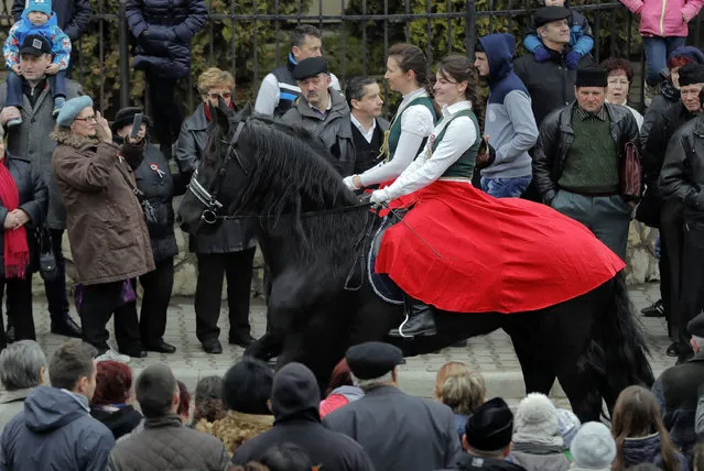 Ethnic Hungarian parade on horseback wearing traditional outfits in Targu Secuiesc, Romania, Wednesday, March 15, 2017. (Photo by Vadim Ghirda/AP Photo)