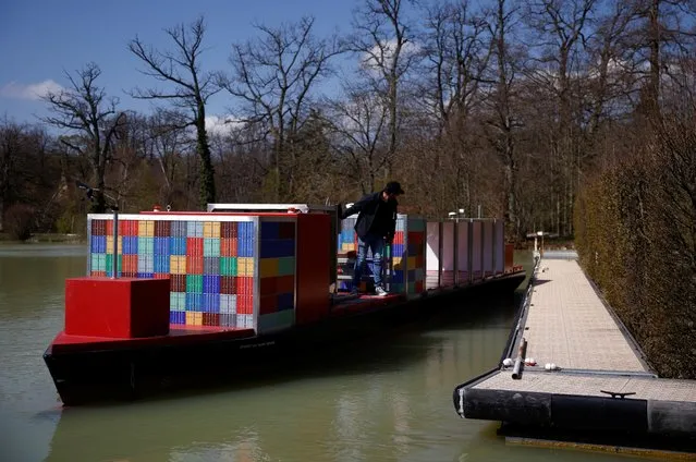 A pilot steers a scaled-down model of an ULCS container ship, named the Spirit of Port Revel, on a lake at the Port Revel Shiphandling Training Centre in Saint-Pierre-de-Bressieux, France, April 19, 2021. Located in the foothills of the Alps, the Port Revel facility is designed to replicate some of the trickiest spots in global shipping. (Photo by Stephane Mahe/Reuters)