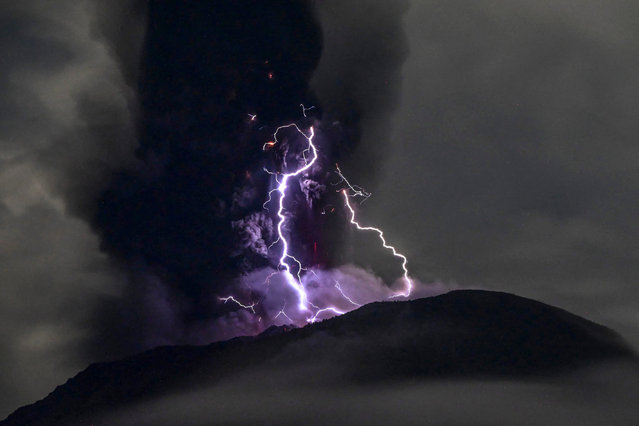 This handout picture taken and released on May 18, 2024 by the Indonesian Geological Agency shows Mount Ibu spewing volcanic ash as lightning strikes, as seen from the monitoring post in West Halmahera, North Maluku. (Photo by Indonesian Geological Agency/Handout via AFP Photo)