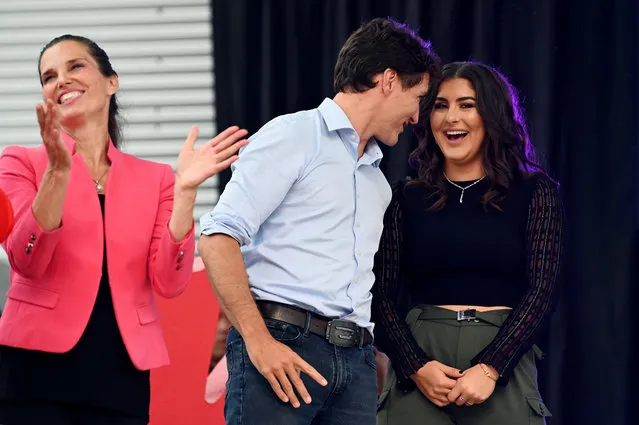 Canada's Prime Minister Justin Trudeau speaks with U.S. Open tennis champion Bianca Andreescu as Canada's Minister of Science and Sport Kirsty Duncan (left) looks on at the “She The North” celebration rally for Andreescu in Mississauga, Ontario, Canada on September 15, 2019. (Photo by Moe Doiron/Reuters)