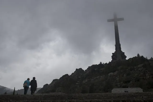 Tourists walk outside of the Spanish former dictator General Francisco Franco's tomb at the Valle de los Caidos (Valley of the Fallen), near Madrid, Tuesday, May 10, 2016. A court decision to order the first-ever exhumation of bodies at Spain's Valley of the Fallen mausoleum where dictator Francisco Franco is buried is re-igniting a debate over whether the memorial site that holds thousands of civil war victims should be disturbed. (Photo by Francisco Seco/AP Photo)