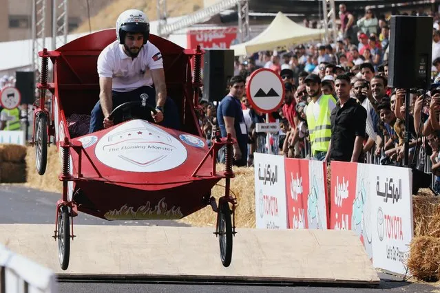 A competitor drives his homemade vehicle without an engine during the Red Bull Soapbox Race in Amman, Jordan on September 20, 2019. (Photo by Muhammad Hamed/Reuters)