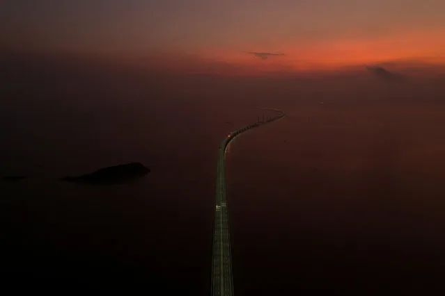 An aerial view shows the Hong Kong-Zhuhai-Macau bridge, a key infrastructure in the Greater Bay Area project, during sunrise off Zhuhai, Guangdong province, China on September 12, 2019. (Photo by Reuters/China Stringer Network)