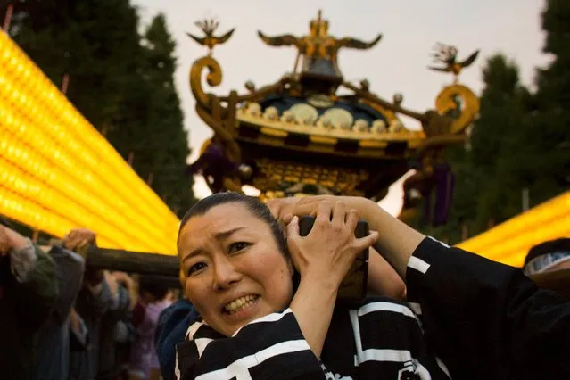 A woman carries a portable shrine during the annual Mitama Festival at the Yasukuni Shrine in Tokyo, Japan, July 13, 2015. (Photo by Thomas Peter/Reuters)