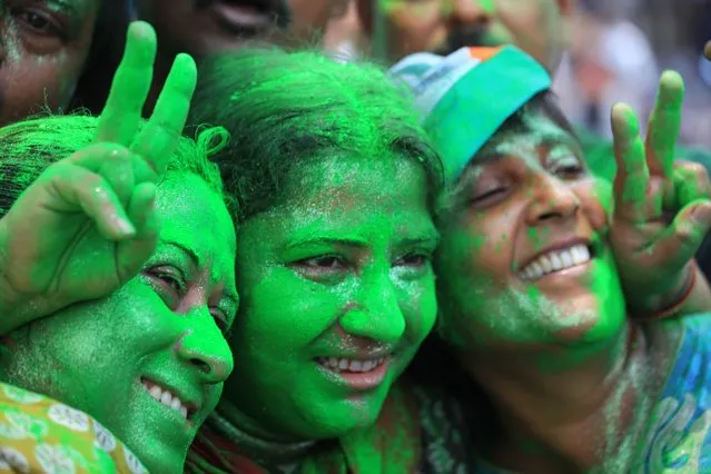 Trinamool Congress Party (TMC) supporters with green faces celebrate the election results near a counting station in Calcutta, India, on May 16, 2014. (Photo by Piyal Adhikary/EPA)