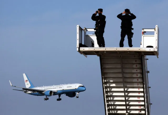 Security personnel stand guard as US Vice President Joe Biden's plane approaches Larnaca airport, Cyprus, 21 May 2014. Biden arrived in Cyprus for a two-days visit. (Photo by Katia Christodoulou/EPA)