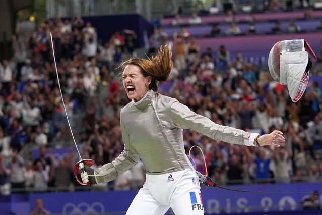 France's Manon Apithy Brunet celebrates after winning the women's individual Sabre quarterfinal match against Greece's Theodora Gkountoura during the 2024 Summer Olympics at the Grand Palais, Monday, July 29, 2024, in Paris, France. (Photo by Andrew Medichini/AP Photo)