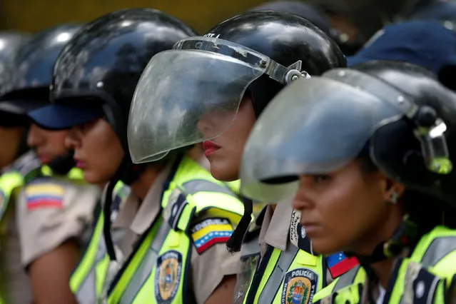Riot police stand guard during a rally to demand an increase in university funding and against Venezuelan President Nicolas Maduro's government in Caracas, Venezuela, May 26, 2016. (Photo by Carlos Garcia Rawlins/Reuters)