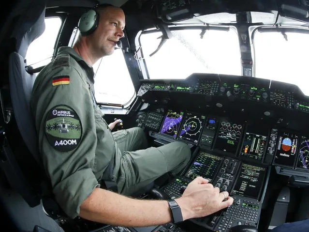 A German Air Force piolt poses inside the cockpit of an Airbus A400M military aircraft at the ILA Berlin Air Show in Schoenefeld, south of Berlin, Germany, June 1, 2016. Picture taken with a fish-eye lens. (Photo by Fabrizio Bensch/Reuters)