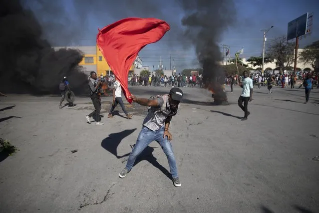 Factory workers protest to demand a salary increase in Port-au-Prince, Haiti, Wednesday, February 23, 2022. (Photo by Joseph Odelyn/AP Photo)