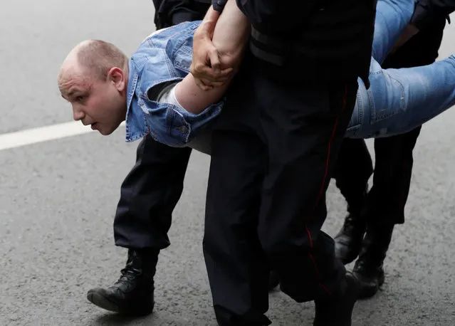 A demonstrator is detained by riot police during an anti-corruption protest organised by opposition leader Alexei Navalny, on Tverskaya Street in Moscow, Russia on Monday, June 12, 2017. (Photo by Tatyana Makeyeva/Reuters)