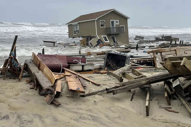 In this image provided by National Park Service, a beach house that collapsed along North Carolina's Outer Banks rest in the water on Tuesday, May 10, 2022, in Rodanthe, N.C. The home was located along Ocean Drive in the Outer Banks community of Rodanthe. The park service has closed off the area and warned that additional homes in the area may fall too. (Photo by National Park Service via AP Photo)