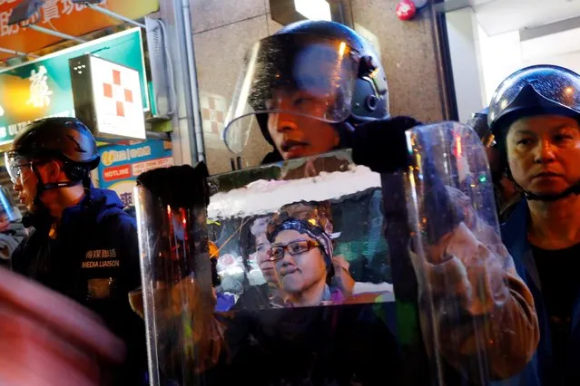 A woman's reflection is seen on a shield used by police officers during a protest in Hong Kong, August 31, 2019. (Photo by Anushree Fadnavis/Reuters)