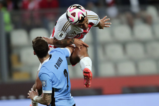 Peru's Alex Valera, top, and Uruguay's Santiago Bueno battle for the ball during a qualifying soccer match for the FIFA World Cup 2026 at National Stadium in Lima, Peru, Friday, October 11, 2024. (Photo by Daniel Apuy/AP Photo)