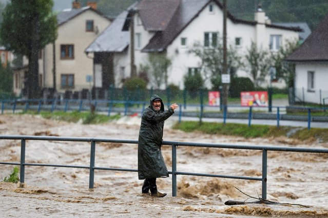 A person wades through a flood-affected road, following heavy rainfall in Jesenik, Czech Republic, on September 15, 2024. (Photo by David W. Cerny/Reuters)