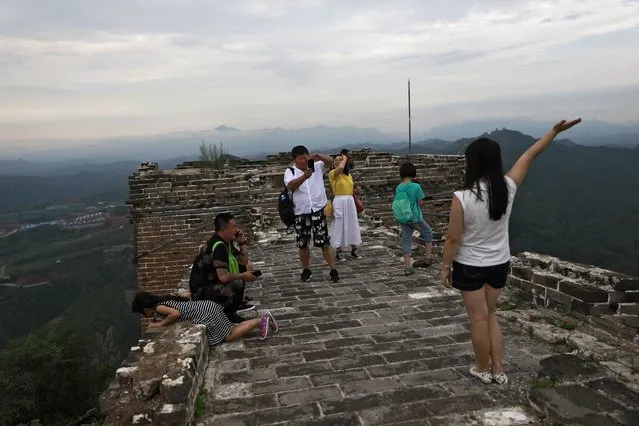People visit a section of the Simatai Great Wall in Miyun county, 120 kilometers northeast of Beijing, China, 23 July 2017. Built during the Northern Qi dynasty (550-577) and rebuilt during the Ming dynasty, the Simatai Great Wall is 5.4 km long with 35 beacon towers and feature some of the less known parts of the Great Wall. It was closed in 2010 but has since opened to tourists in 2014. China's Great Wall was designated by UNESCO as a World Cultural Heritage site in 1987. (Photo by How Hwee Young/EPA/EFE)