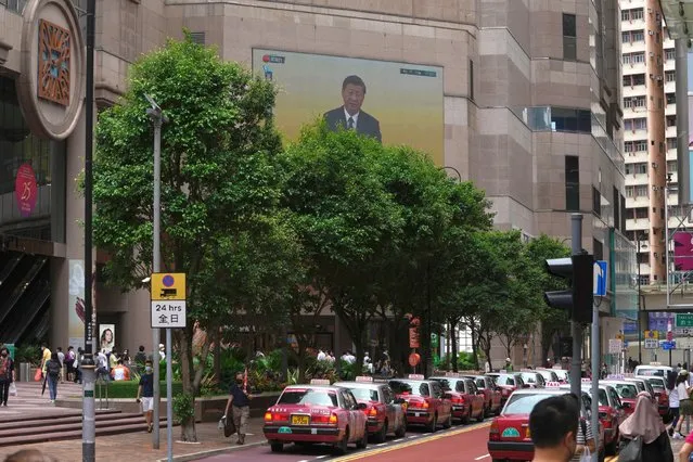 A TV screen shows the live broadcast of China's President Xi Jinping's speech following a swearing-in ceremony to inaugurate the city's new leader and government in Hong Kong, Friday, July 1, 2022. The city on Friday marked the 25th anniversary of its return to Chinese rule. (Photo by Kin Cheung/AP Photo)