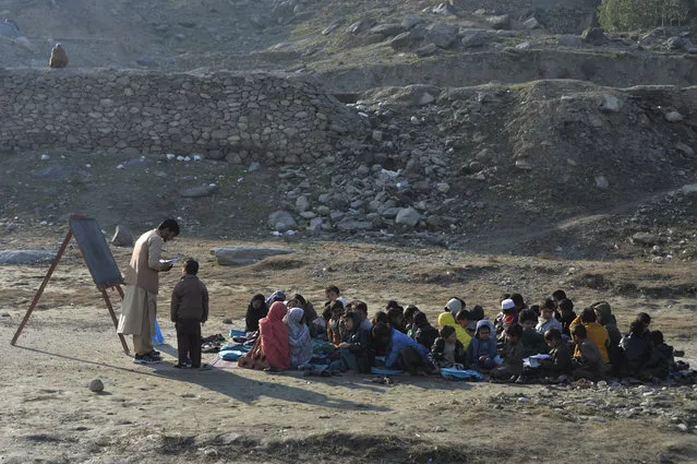 School children take part in a lesson in an open-air classroom in Qarghayi district of Laghman Province on January 20, 2020. (Photo by Noorullah Shirzada/AFP Photo)