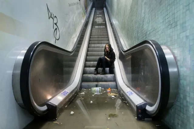 A woman calls for assistance after being trapped by water at a flooded Ryparken S-train station during a heavy rainstorm in Copenhagen August 31, 2014. (Photo by Jens Astrup/Reuters/Scanpix Denmark)