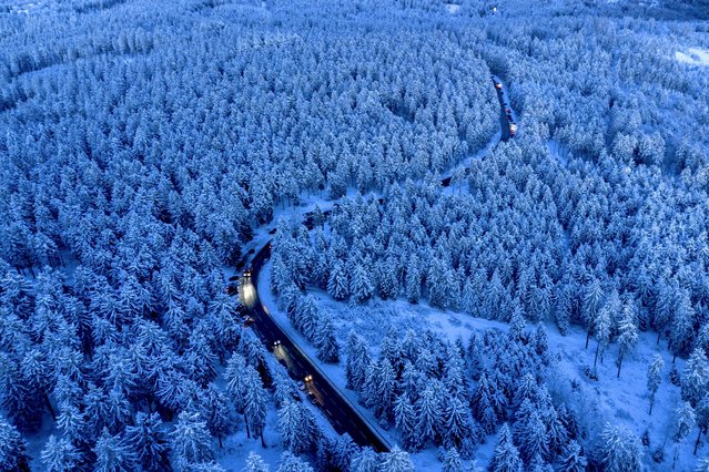 Cars drive up to the top of the Feldberg mountain near Frankfurt, Germany, Thursday evening, January 2, 2025. (Photo by Michael Probst/AP Photo)